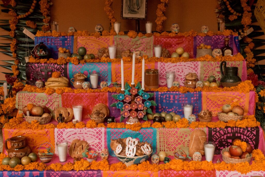 Vibrant Dia de los Muertos altar with traditional offerings in Puebla, Mexico.